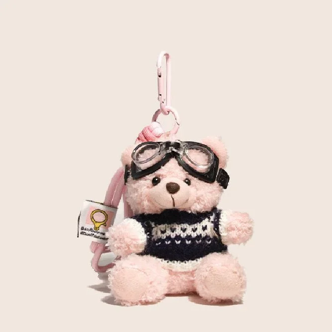 Bijou de sac ours aviateur rose en pull noir et blanc